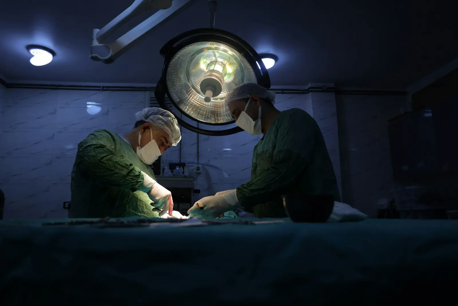 Surgical team working under operating lights at night