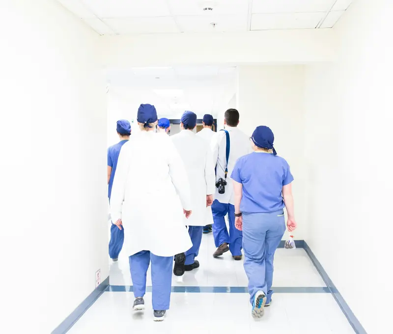 Clinical team walking down a hospital corridor